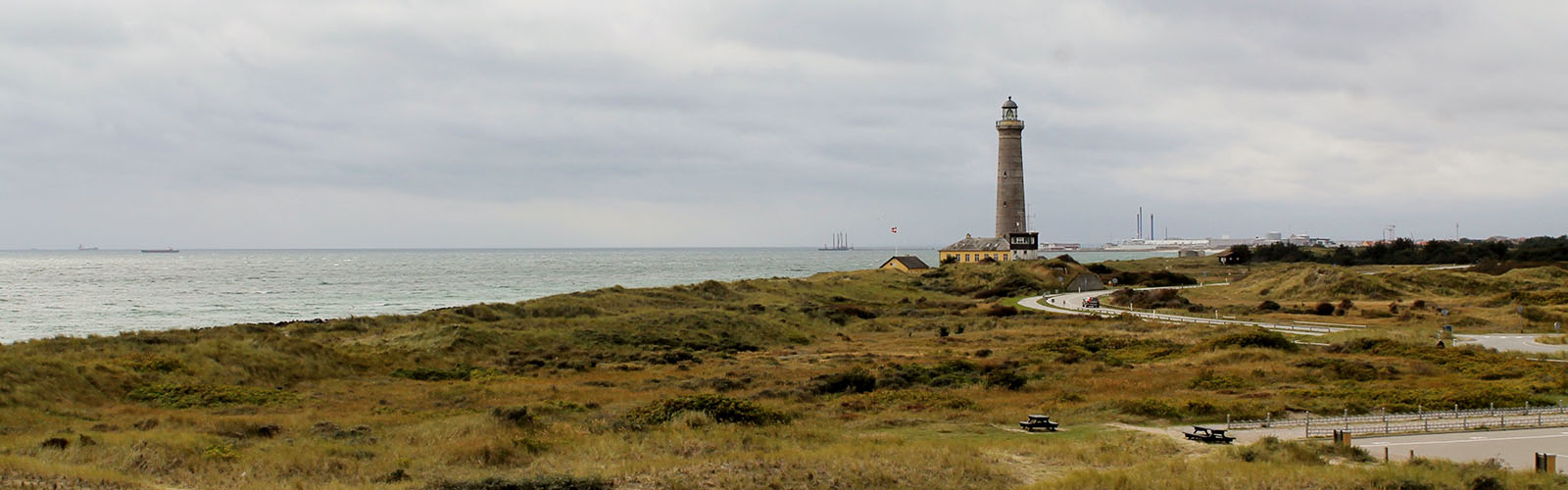 View of the beach with a lighthouse in the background